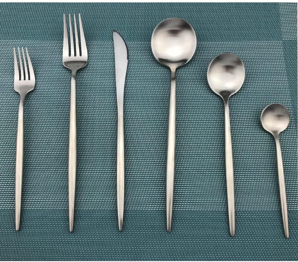 Fitlybuy Torin minimalist stainless steel cutlery set with a matte finish, laid out on a teal textured placemat.