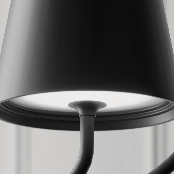 Matte black Fitlybuy LumiCord wireless hanging lamp with a glowing LED base in a modern, minimalist interior setting.