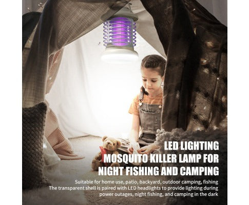 Fitlybuy purple LED mosquito zapper hanging in a camping tent while a child plays with a teddy bear.