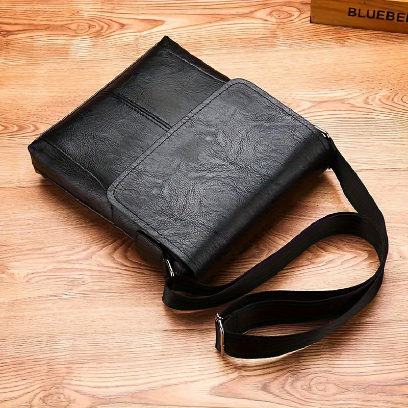 Black Fitlybuy vintage PU leather shoulder bag with adjustable strap on a wood surface.
