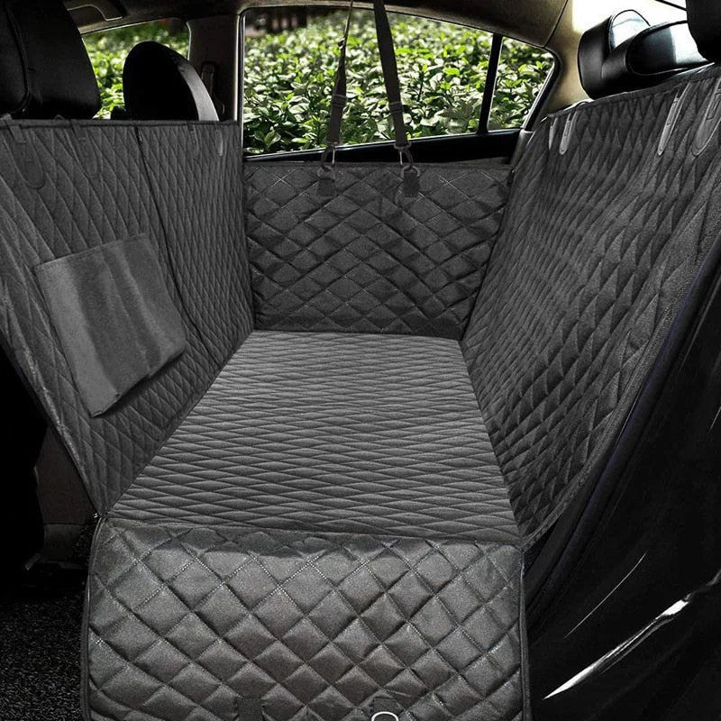 Gray, quilted waterproof dog car seat cover with padded comfort, installed in a vehicle’s back seat.