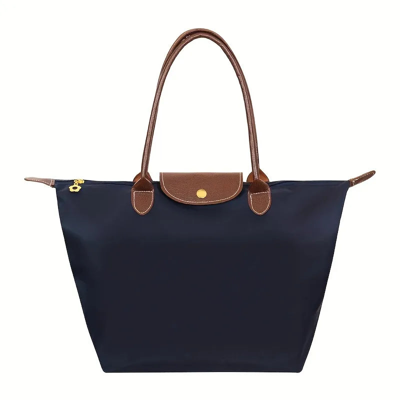 Fitlybuy navy blue tote handbag with brown leather trim, gold snap closure, and zipper, on a plain white background.