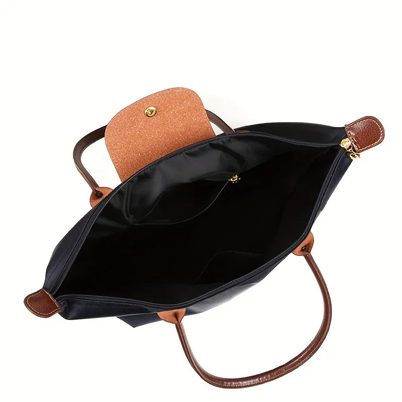 Open navy blue Fitlybuy handbag with brown leather handles and snap-flap closure, showing a spacious interior.