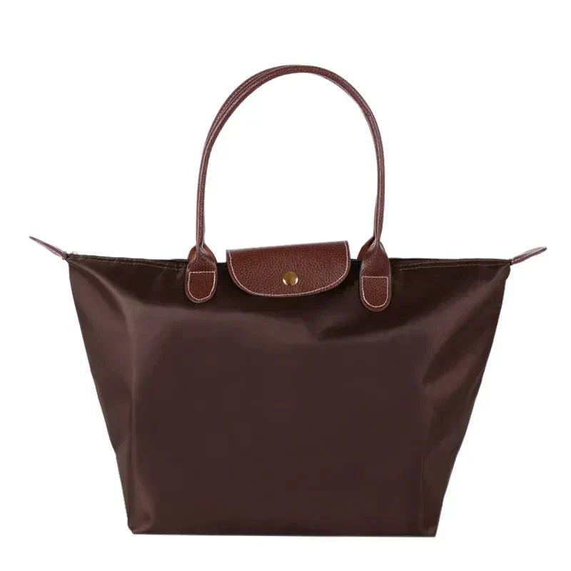 Fitlybuy brown nylon tote handbag with leather-textured handles and a snap-button flap closure on a white background.