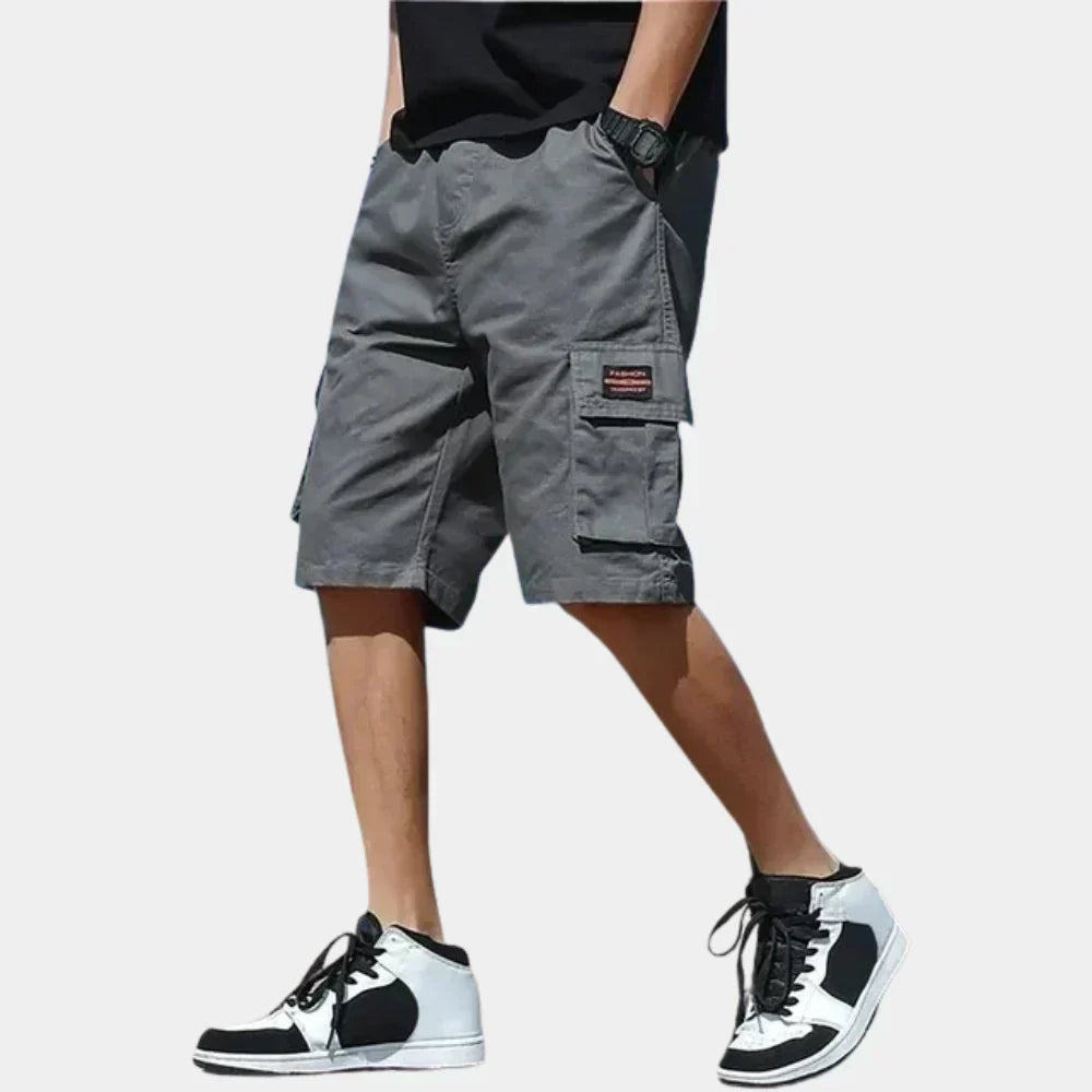 Fitlybuy men’s grey cotton cargo shorts with side pockets, loose fit, and a black fashion label on the thigh.