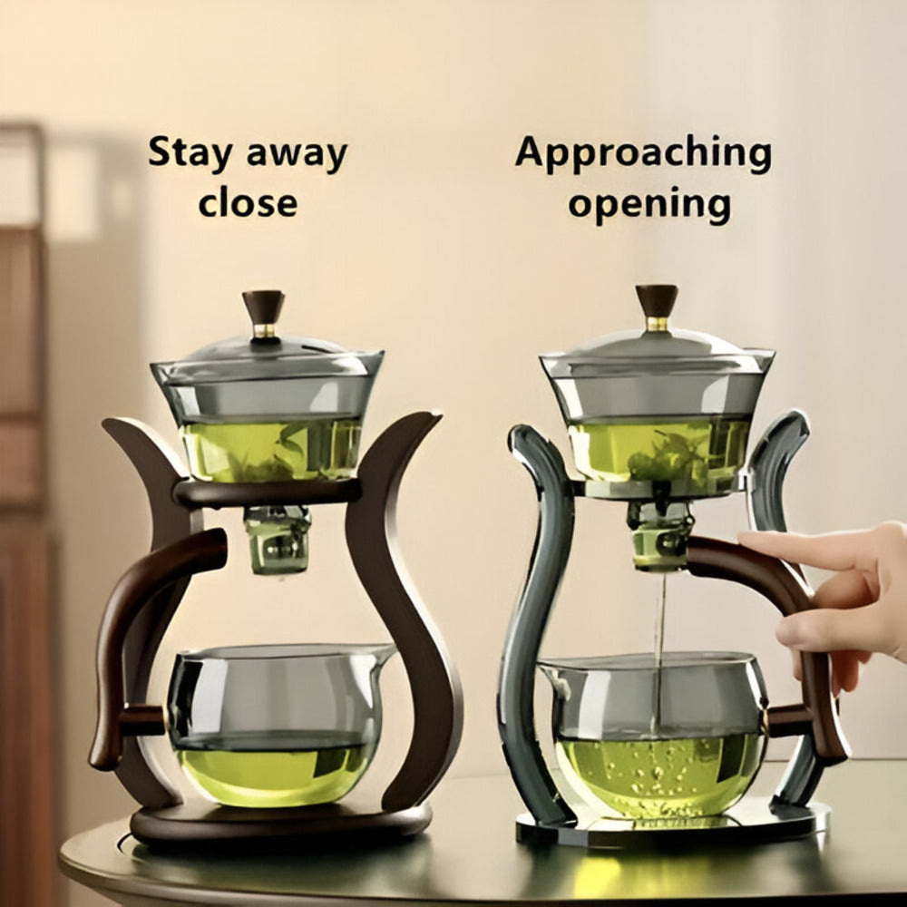 Fitlybuy artisan magnetic glass teapot set showing drip-free infusion mechanism with a hand operating the magnetic flow.
