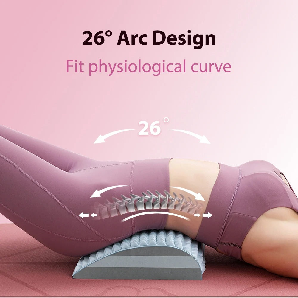 Fitlybuy back stretcher with a grey 26-degree arched lumbar support under a woman's lower back on a yoga mat.