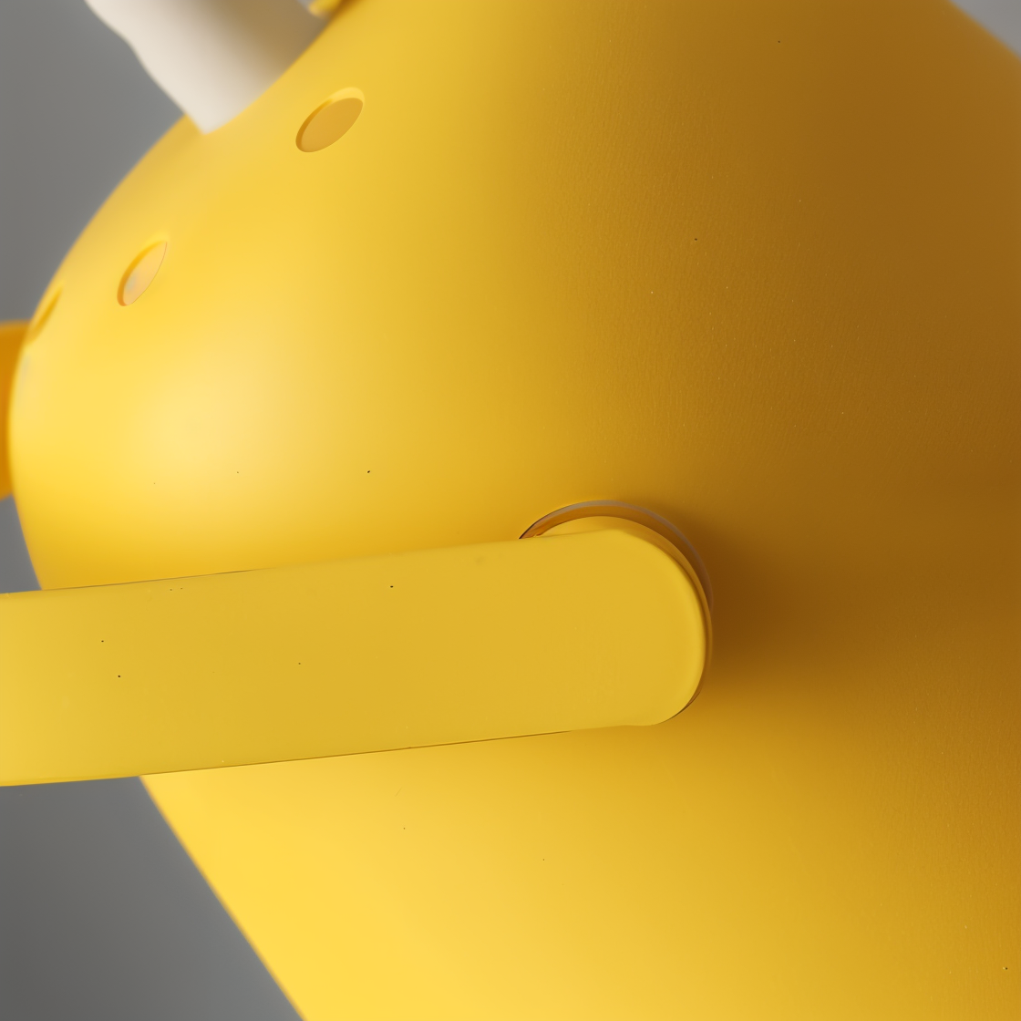Close-up of a Nordic yellow Fitlybuy Macaron desk lamp, highlighting its adjustable matte finish head and ventilation.