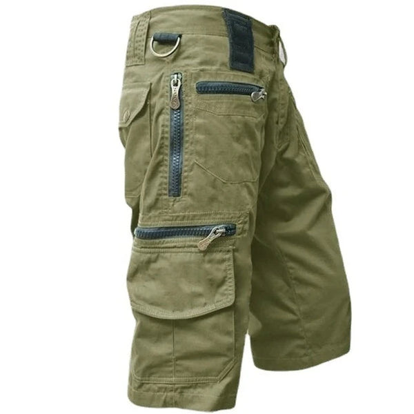 Olive green men's outdoor cargo shorts with multiple zippered utility pockets, D-ring, and durable stretch fabric.