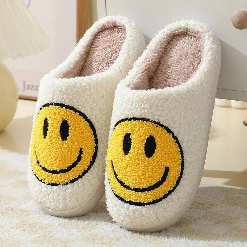 Fitlybuy Nordic fuzzy white slippers featuring yellow smiley face patches and memory foam cushioning on a bedroom floor.