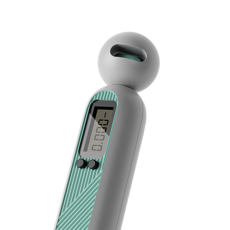 Fitlybuy gray and teal cordless digital skipping rope handle with an LCD screen displaying distance tracking.