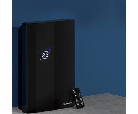Black 2L Fitlybuy dehumidifier and air purifier with digital display and remote on a grey surface against a blue wall.