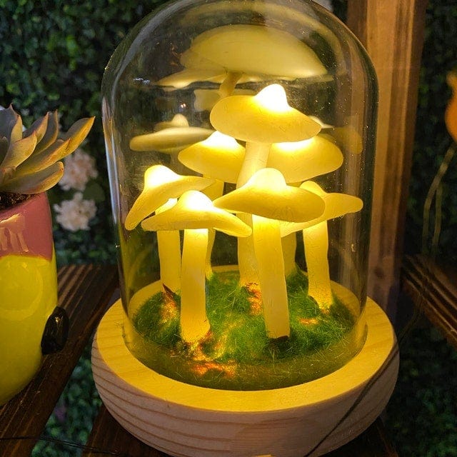 Fitlybuy Enchanted Mushroom glass dome lamp with glowing yellow LED fungi on a green mossy base, wooden stand.