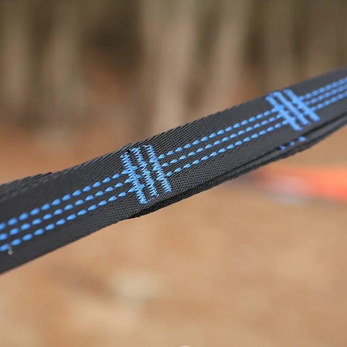 Close-up of a black Fitlybuy hammock strap with durable blue stitching, designed for outdoor camping use.