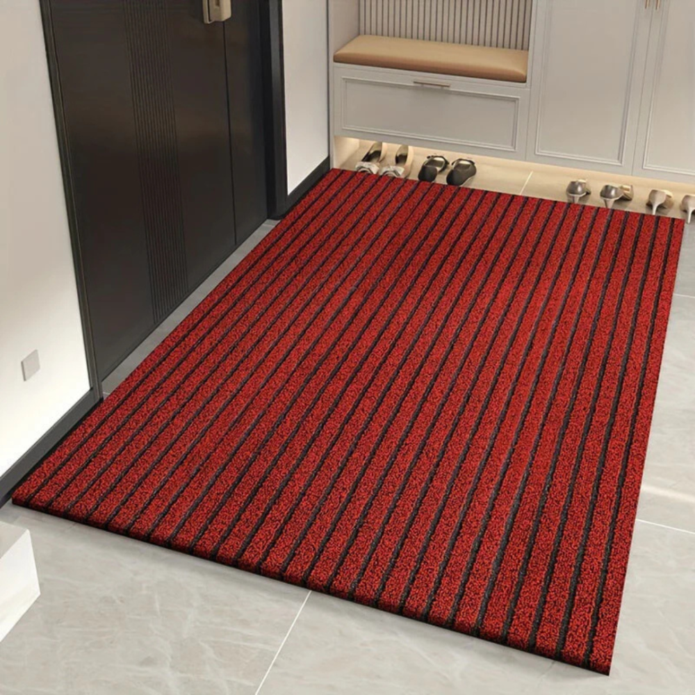 Red and black striped Fitlybuy Duramat all-weather door mat on a tile floor in an entryway.
