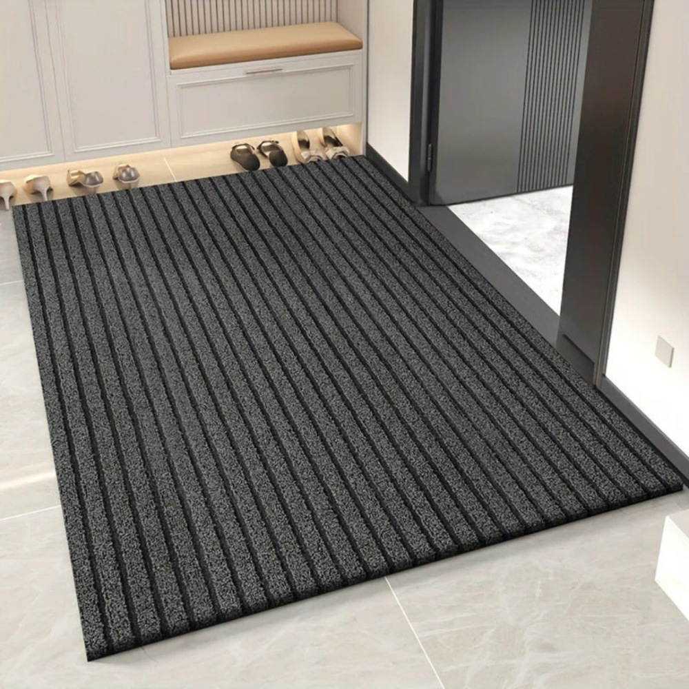 Grey ribbed Fitlybuy Duramat indoor/outdoor door mat on a tiled entryway floor in front of a doorway.