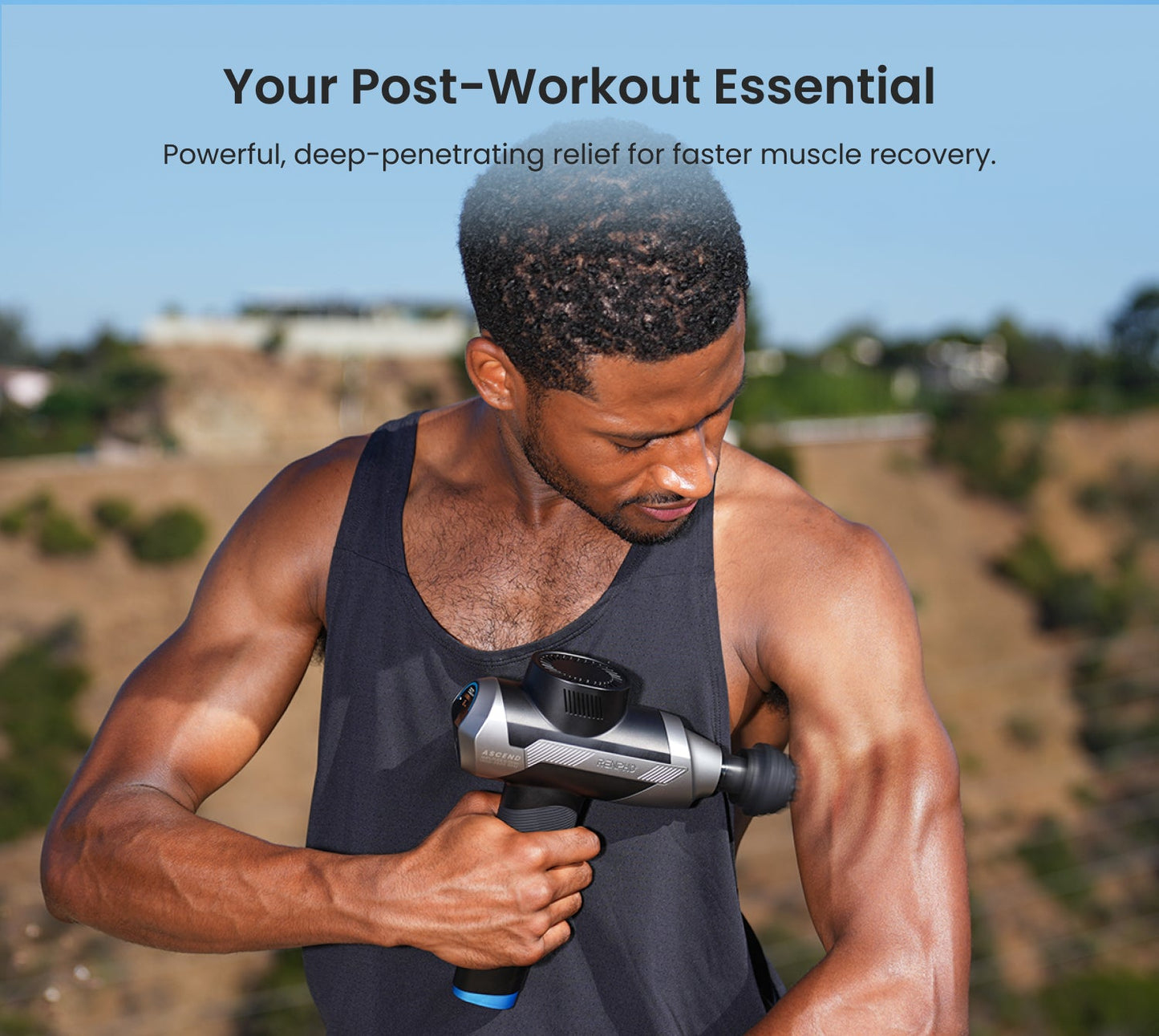 Fitlybuy Ascend grey massage gun with HyperPulse technology being used by a man on his arm for post-workout recovery.