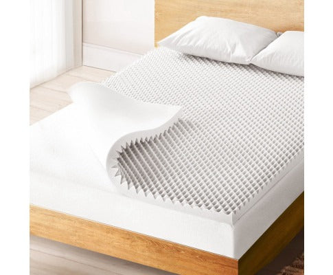 White Fitlybuy egg crate memory foam mattress topper with cooling gel texture on a bed with pillows.