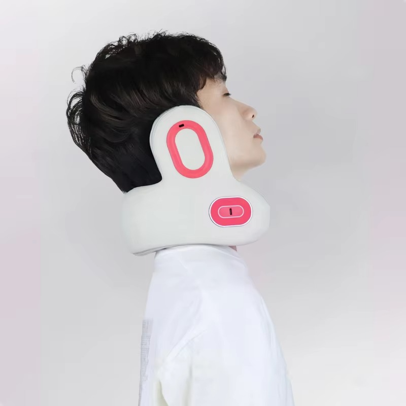 Person wearing a white, ergonomic Fitlybuy electric neck traction device with pink heat technology accents.