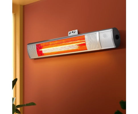 Fitlybuy 2000W infrared radiant heater mounted on an orange wall, glowing bright orange with HeatWave technology.