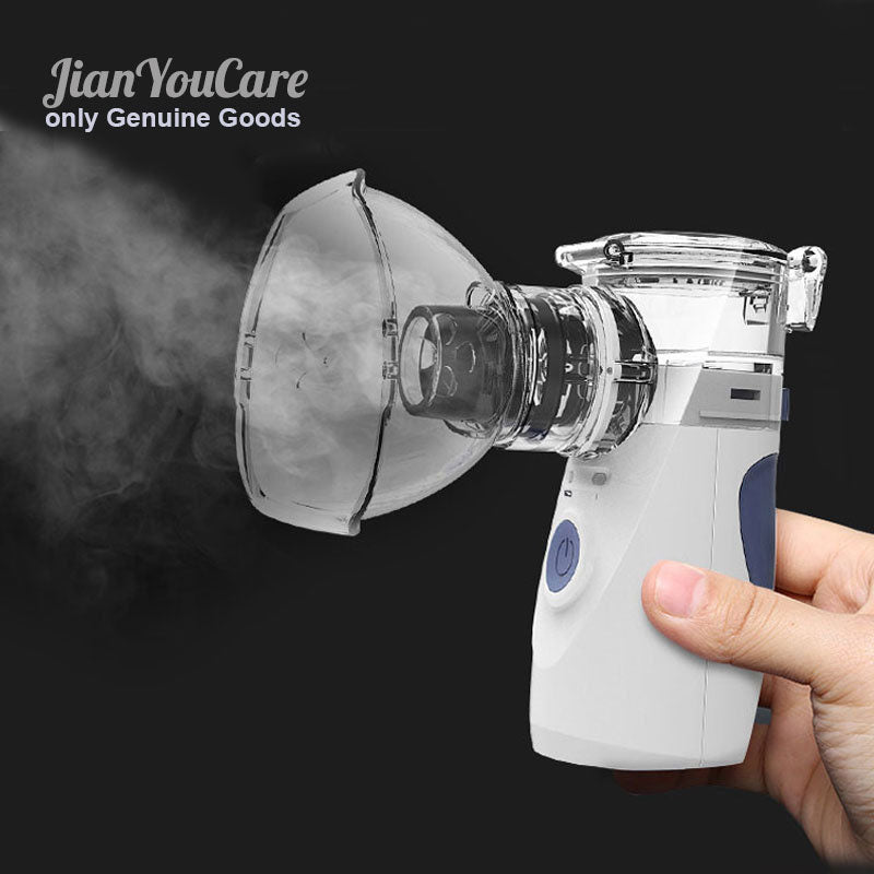 Fitlybuy handheld portable nebulizer with clear mask, white and blue body, emitting mist on a dark background.