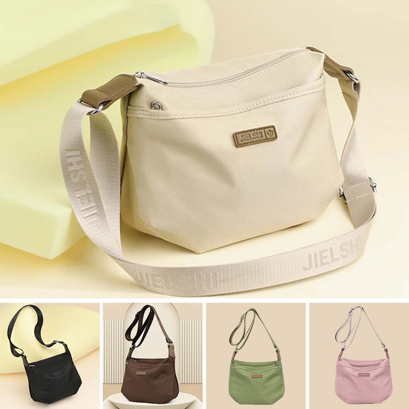 Beige Fitlybuy Joanna anti-theft crossbody bag with wide strap, visible branding, and multiple color variations below.
