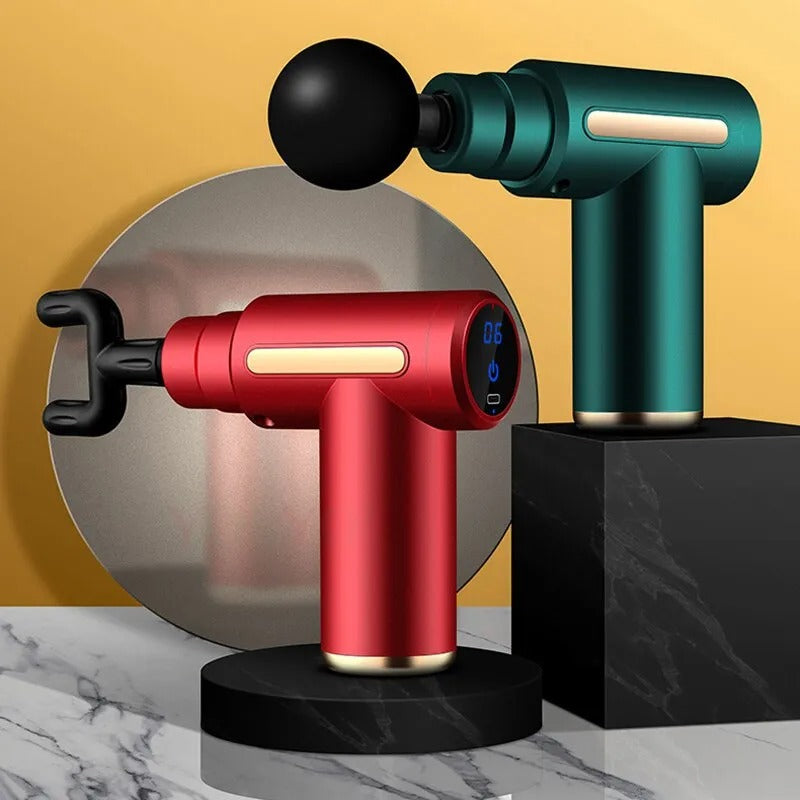 Fitlybuy red and green muscle massage guns with LCD displays and attachments on black stands against a yellow backdrop.