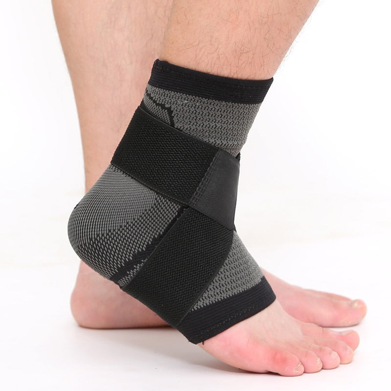 Fitlybuy black and grey compression ankle brace with adjustable stabilizing straps worn on a foot against white background.