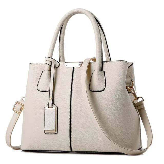 Elegant off-white PU leather handbag with top handles, detachable crossbody strap, and gold-tone hardware details.