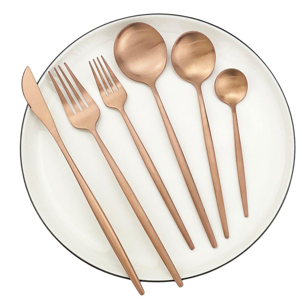 Fitlybuy Torin 36-piece stainless steel cutlery set with an elegant matte rose gold finish, arranged on a white plate.