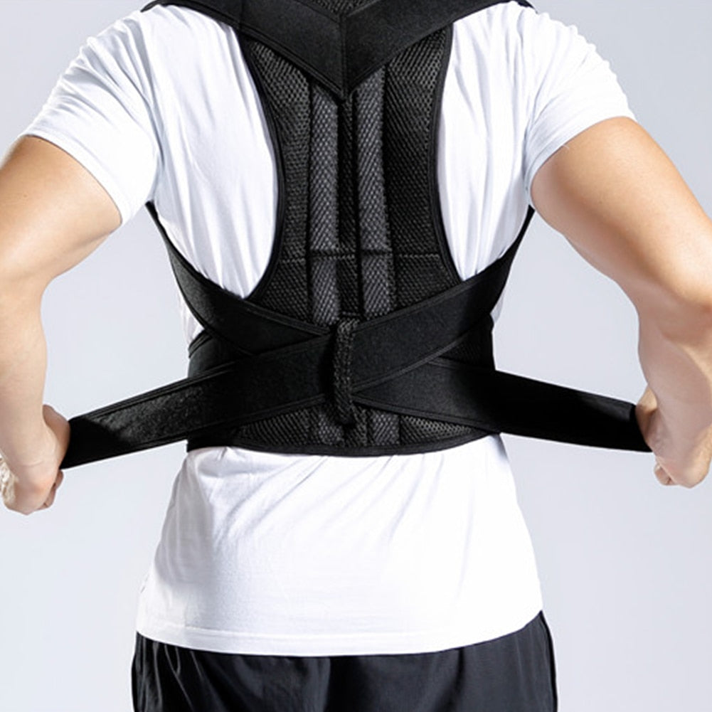 Person wearing a black Fitlybuy Posture Corrector Pro with ergonomic mesh support and adjustable straps over a white tee.