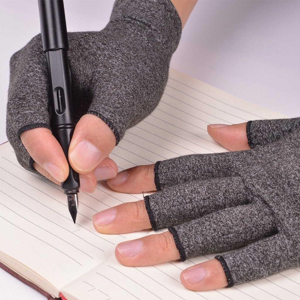 Grey fingerless compression gloves with ThermoFlex fabric being worn to write in a notebook with a black fountain pen.