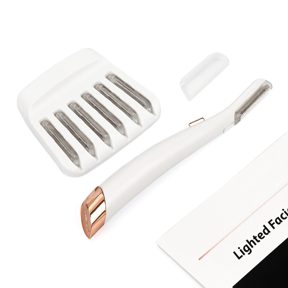 Fitlybuy white and rose gold facial hair remover with five replacement heads and instruction manual on white background.