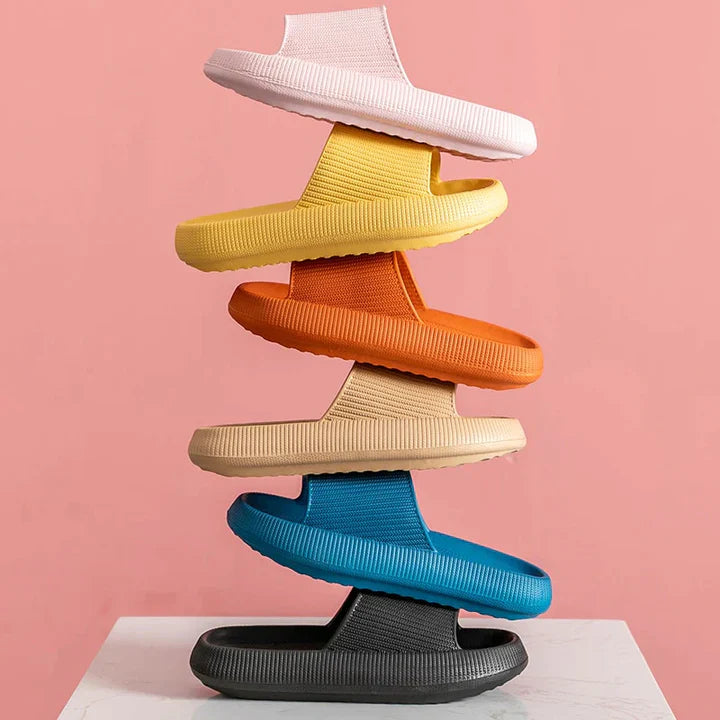 Stack of multi-colored Fitlybuy Cloud Slides with ComfortFoam cushioning, featuring textured, thick-sole, slip-on design.