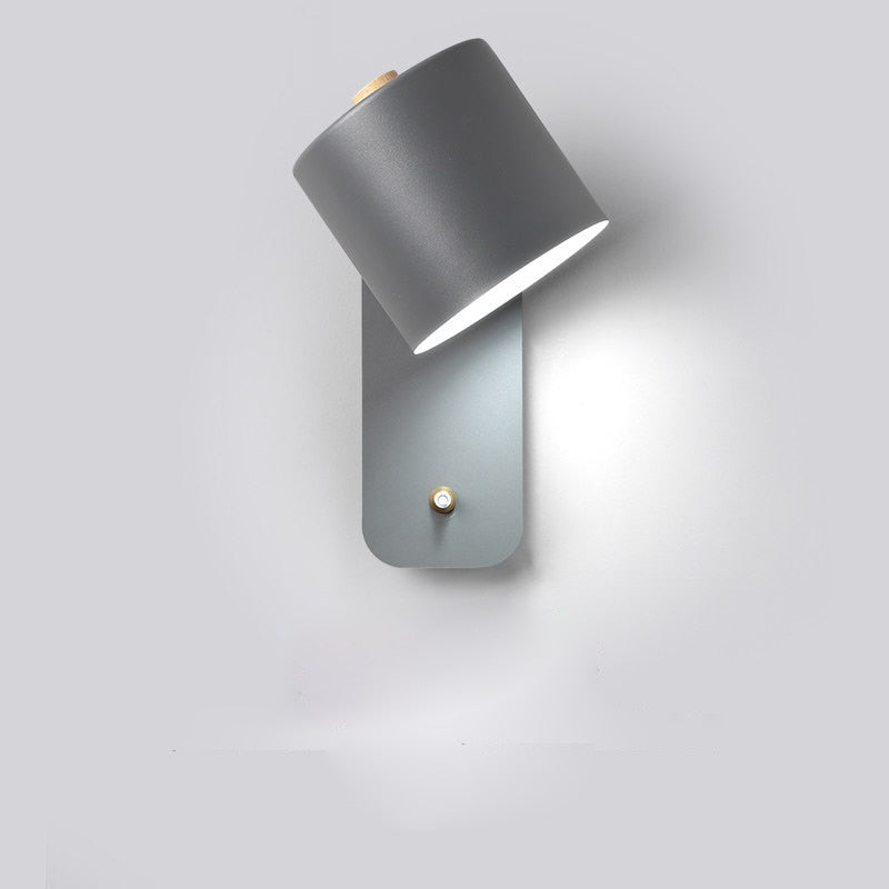 Modern grey LED wall lamp with adjustable cylindrical head and smart switch, mounted on a plain white wall.