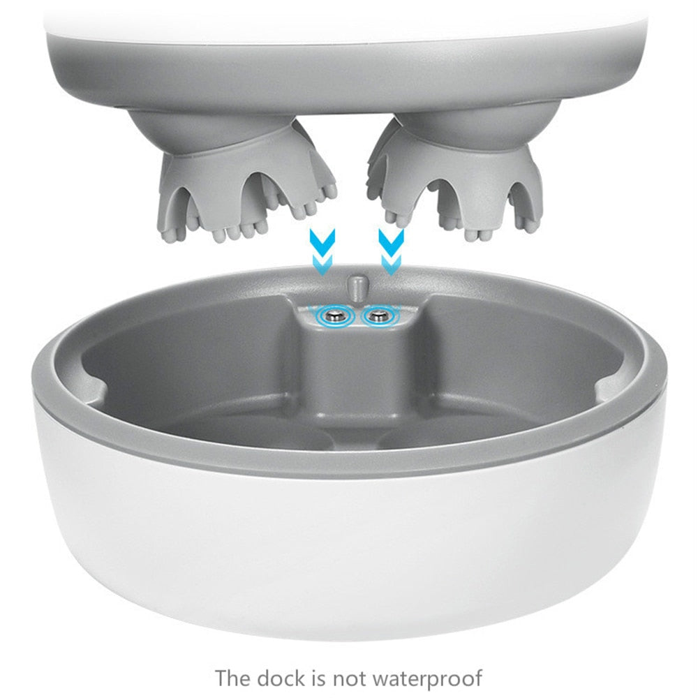Fitlybuy white and gray wireless scalp massager with waterproof heads hovering over its non-waterproof charging dock.