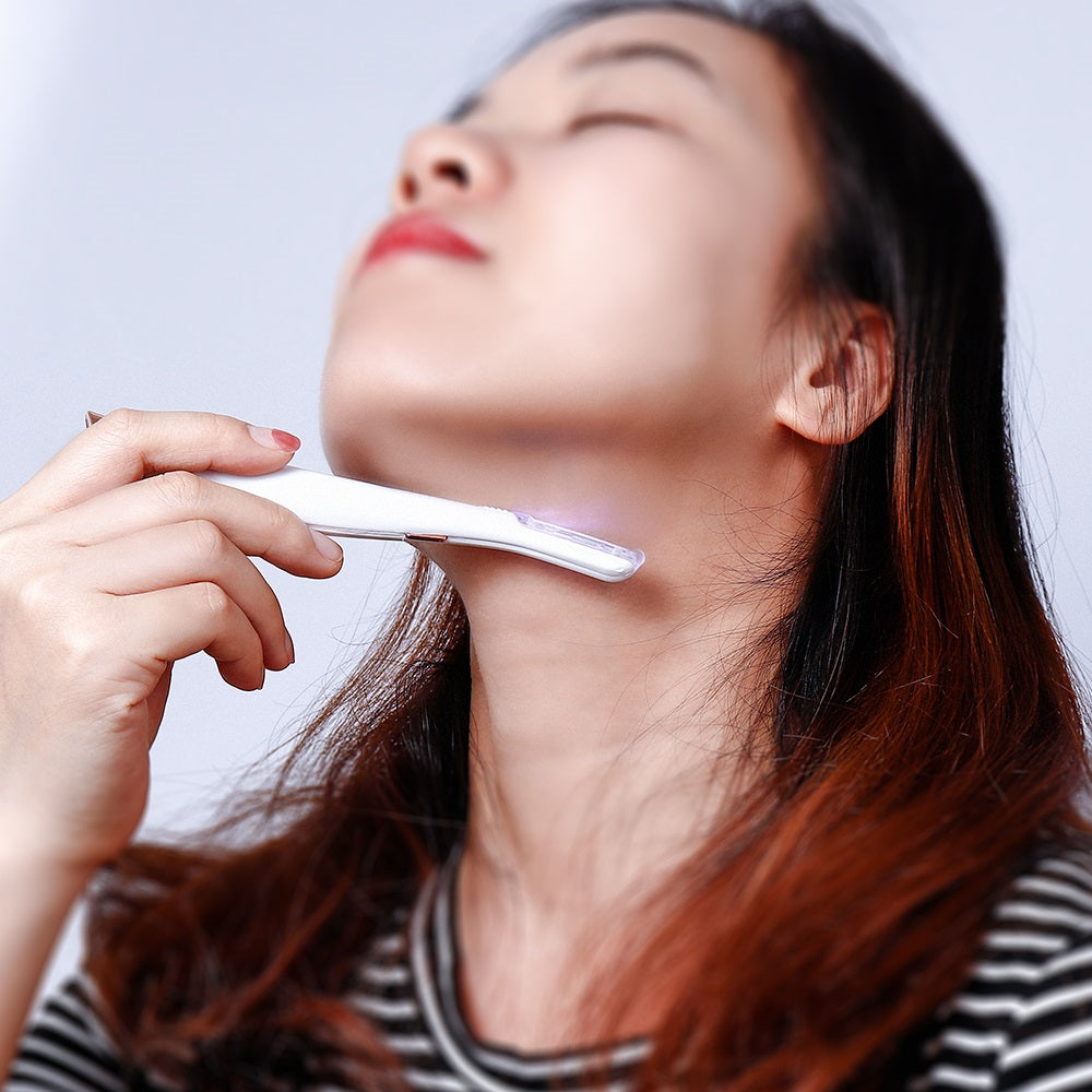 Woman using a white Fitlybuy SoftSkin facial hair remover with painless light technology on her neck.