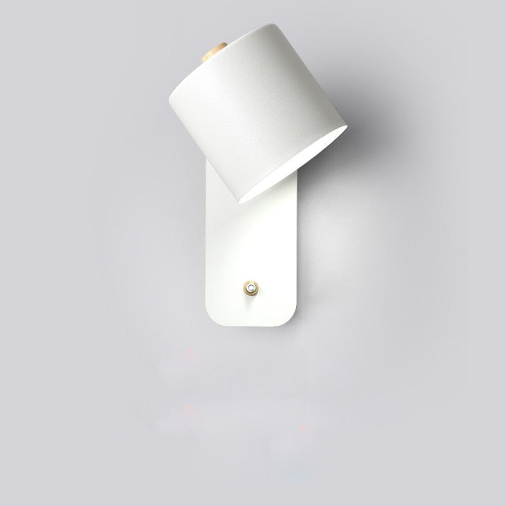 Minimalist white LED wall light with wooden accent, adjustable swivel head, and integrated power switch on wall plate.
