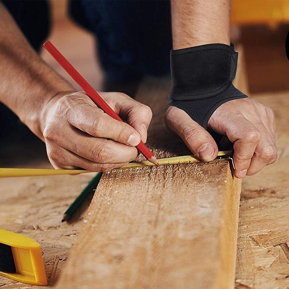 Fitlybuy black carpal tunnel brace worn by a woodworker measuring a wooden plank with a pencil and tape measure.