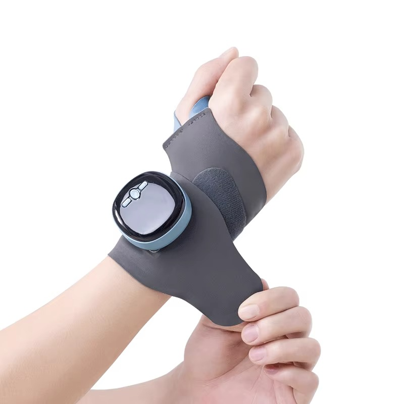 Fitlybuy gray EMS heating wrist brace with digital control unit, worn on a hand to provide tendon relief and therapy.