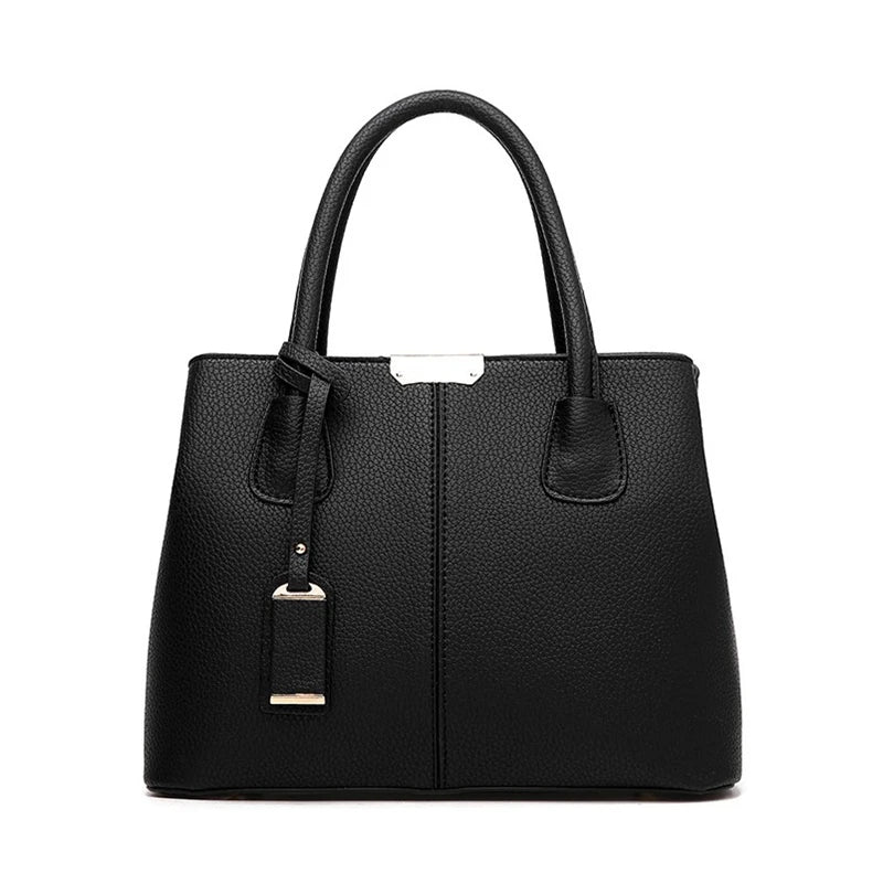 Fitlybuy black pebbled PU leather handbag with top handles, silver hardware, and a matching hanging luggage tag.