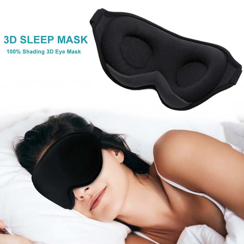 Black Fitlybuy 3D memory foam sleep mask worn by a woman sleeping on a white pillow, showing molded eye cups.