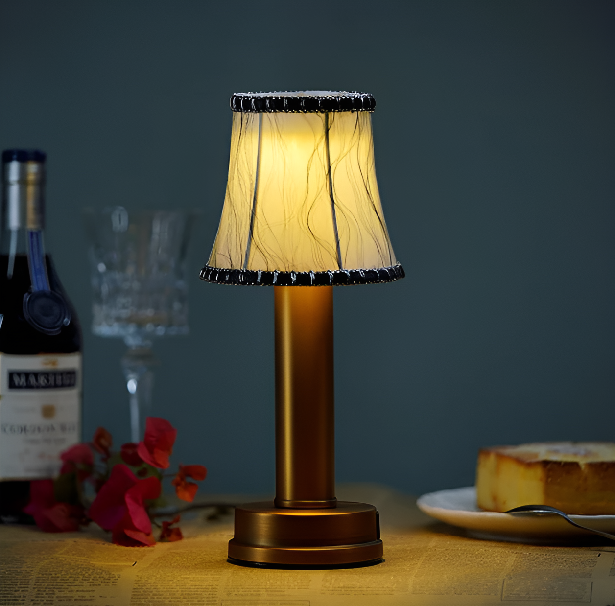 Fitlybuy vintage dimmable gold aluminium table lamp with a patterned fabric shade on a table with wine and cake.