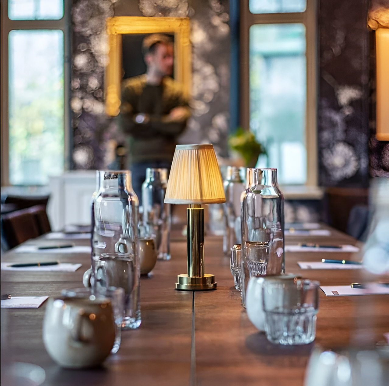 Fitlybuy vintage dimmable gold aluminium table lamp with a pleated fabric shade on a rustic boardroom meeting table.