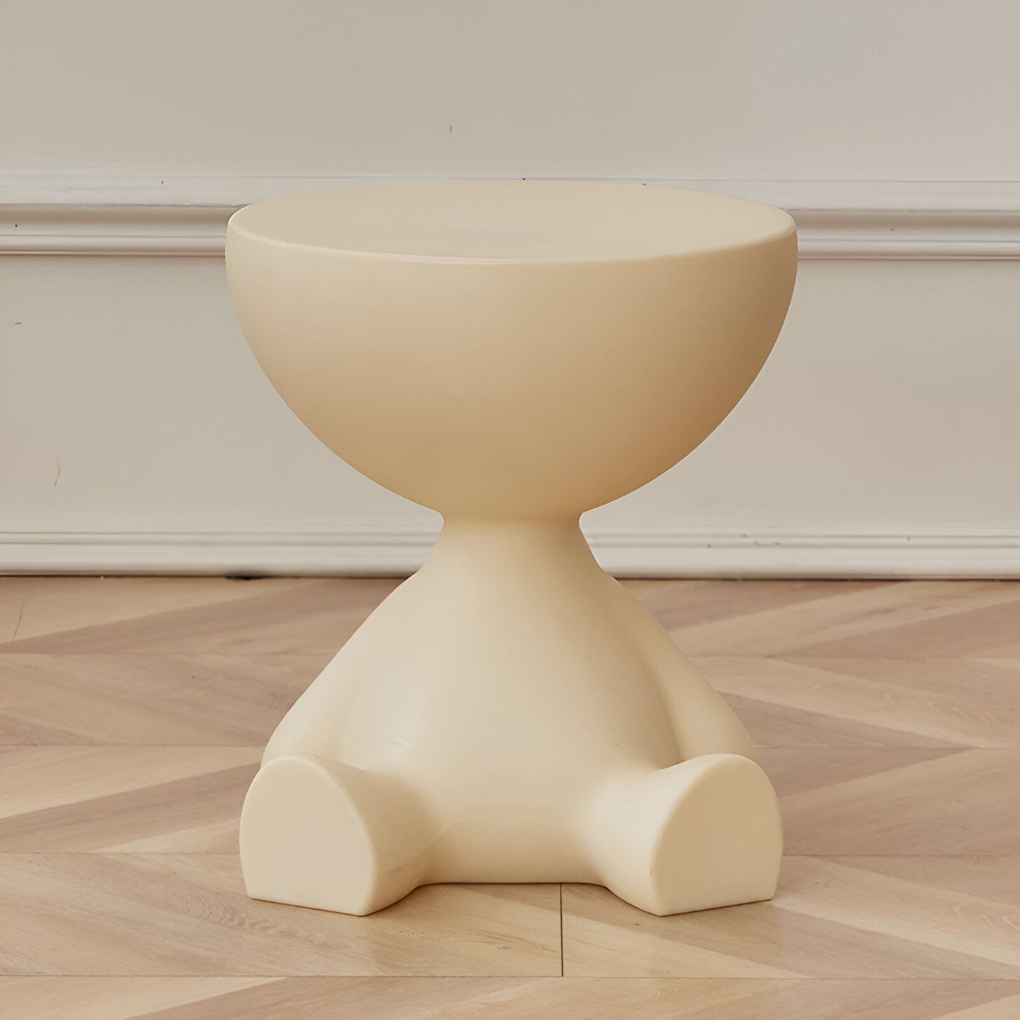 Fitlybuy Ylix round cream-colored coffee table with a whimsical, character-inspired base on a wood floor.