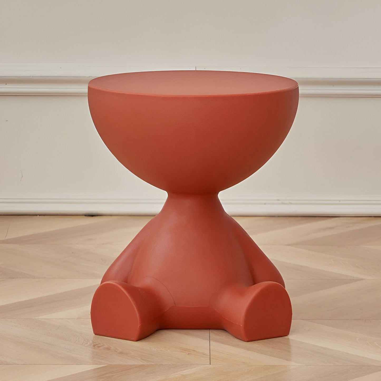 Fitlybuy Ylix terracotta-colored round coffee table with a sculptural, seated figure-shaped base on hardwood floors.