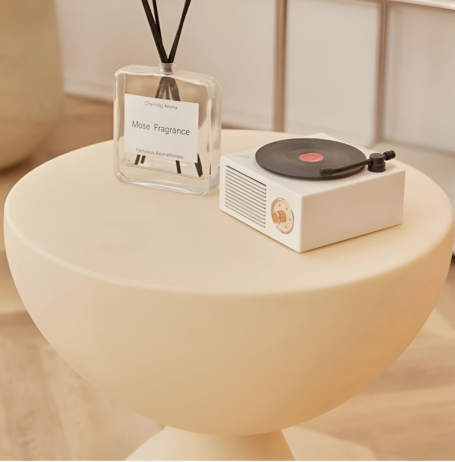 Fitlybuy Ylix round cream-colored coffee table with pedestal base, styled with a glass reed diffuser and record player.