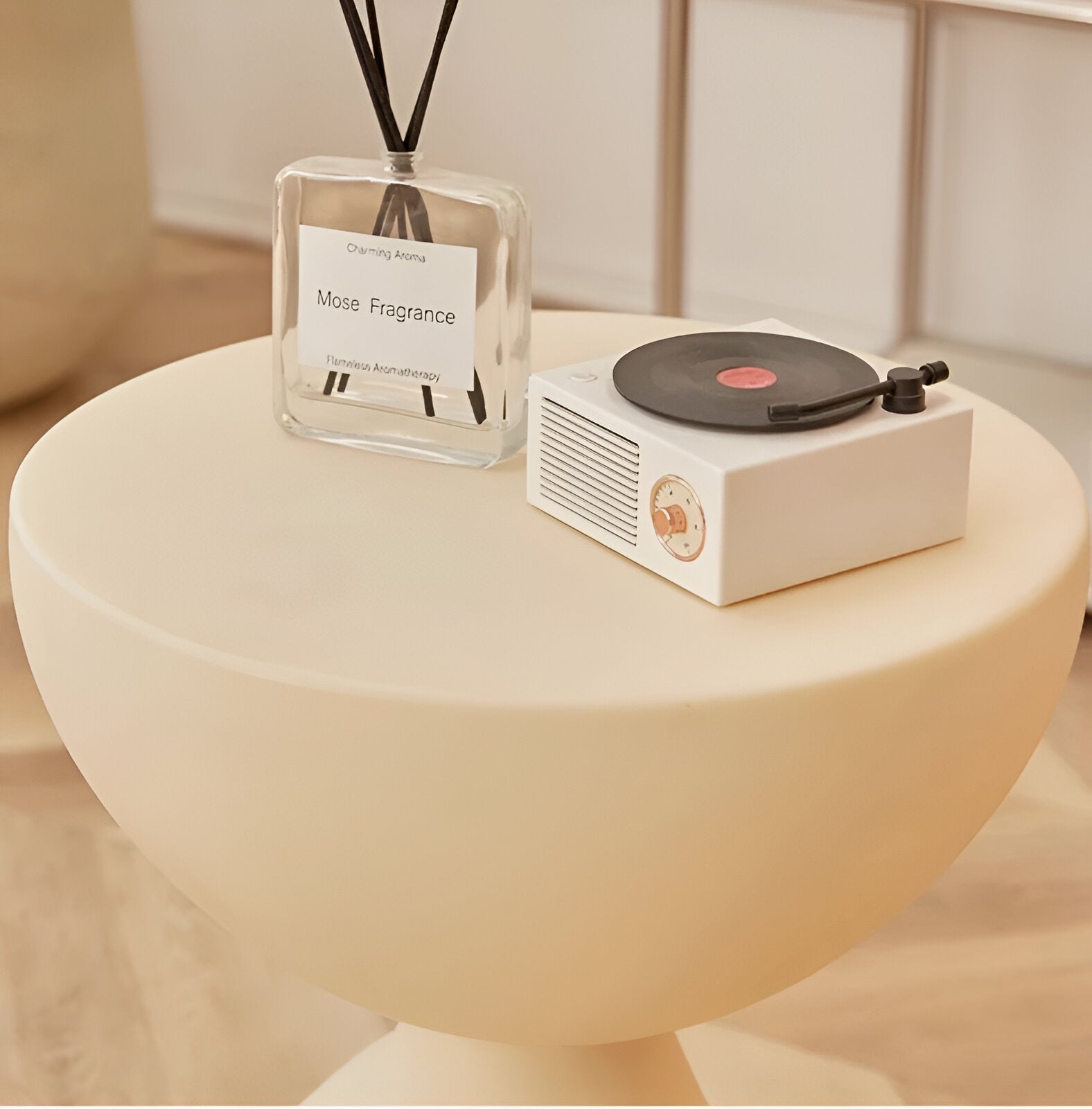 Fitlybuy Ylix round cream-colored coffee table with pedestal base, styled with a glass reed diffuser and record player.