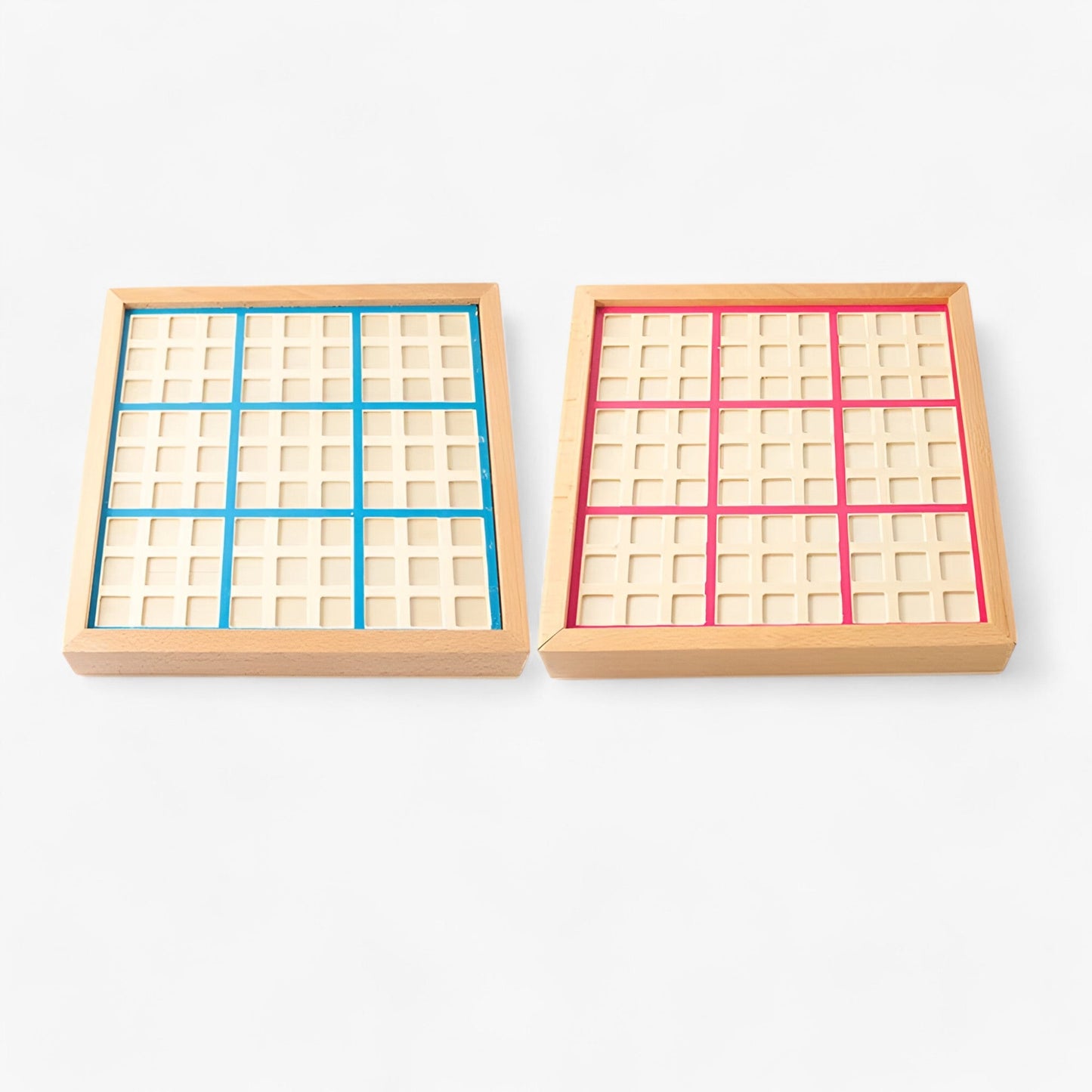 Two wooden Sudoku game boards, one with blue accents and one with pink, showing the 9x9 grid layout on a white background.