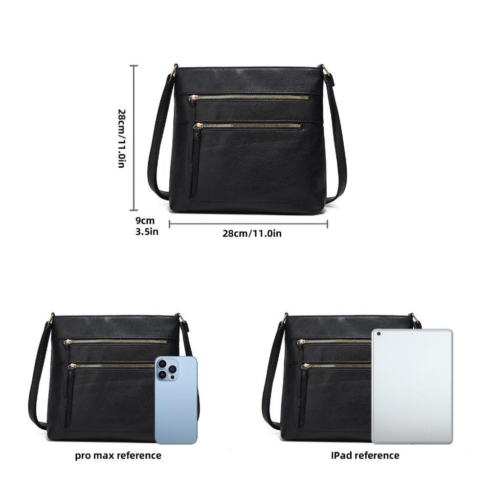 Fitlybuy Nina black leather crossbody bag, 28x28x9cm, with gold zippers, shown next to phone and tablet for scale.